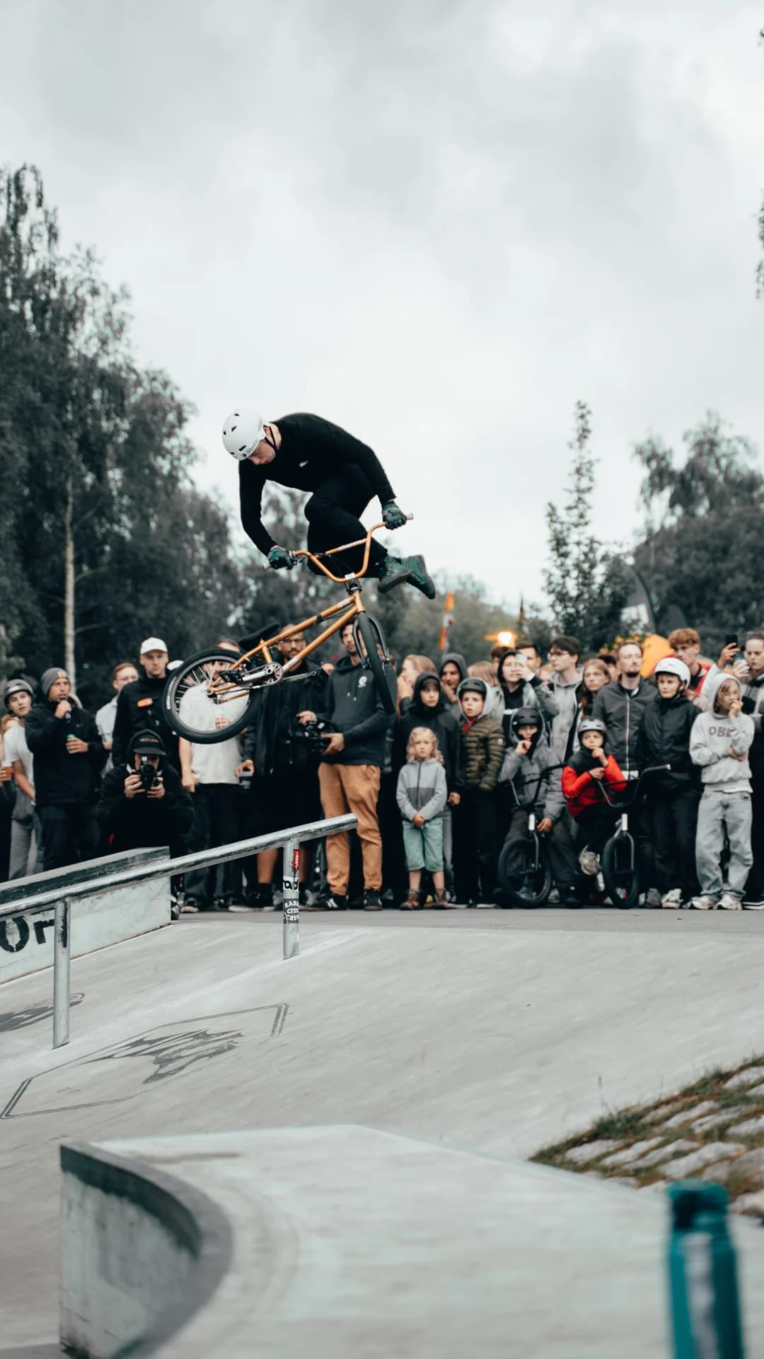 BMX rider catching air at a skatepark event